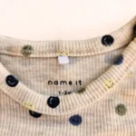 بادی آستین بلند کبریتی خریدطرح شکلک های خندان رنگ کرم برند name it