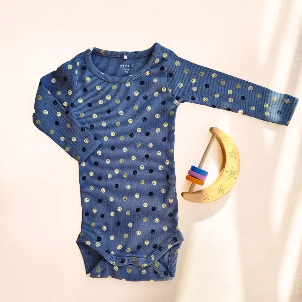 بادی آستین بلند کبریتی طرح شکلک های خندان رنگ آبی تیره برند name it