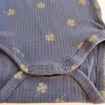 خریدبادی آستین بلند کبریتی طرح برگ شبدر رنگ آبی تیره برند name it