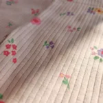 شلوار نوزادی کبریتی طرح گل رنگ کرم برند